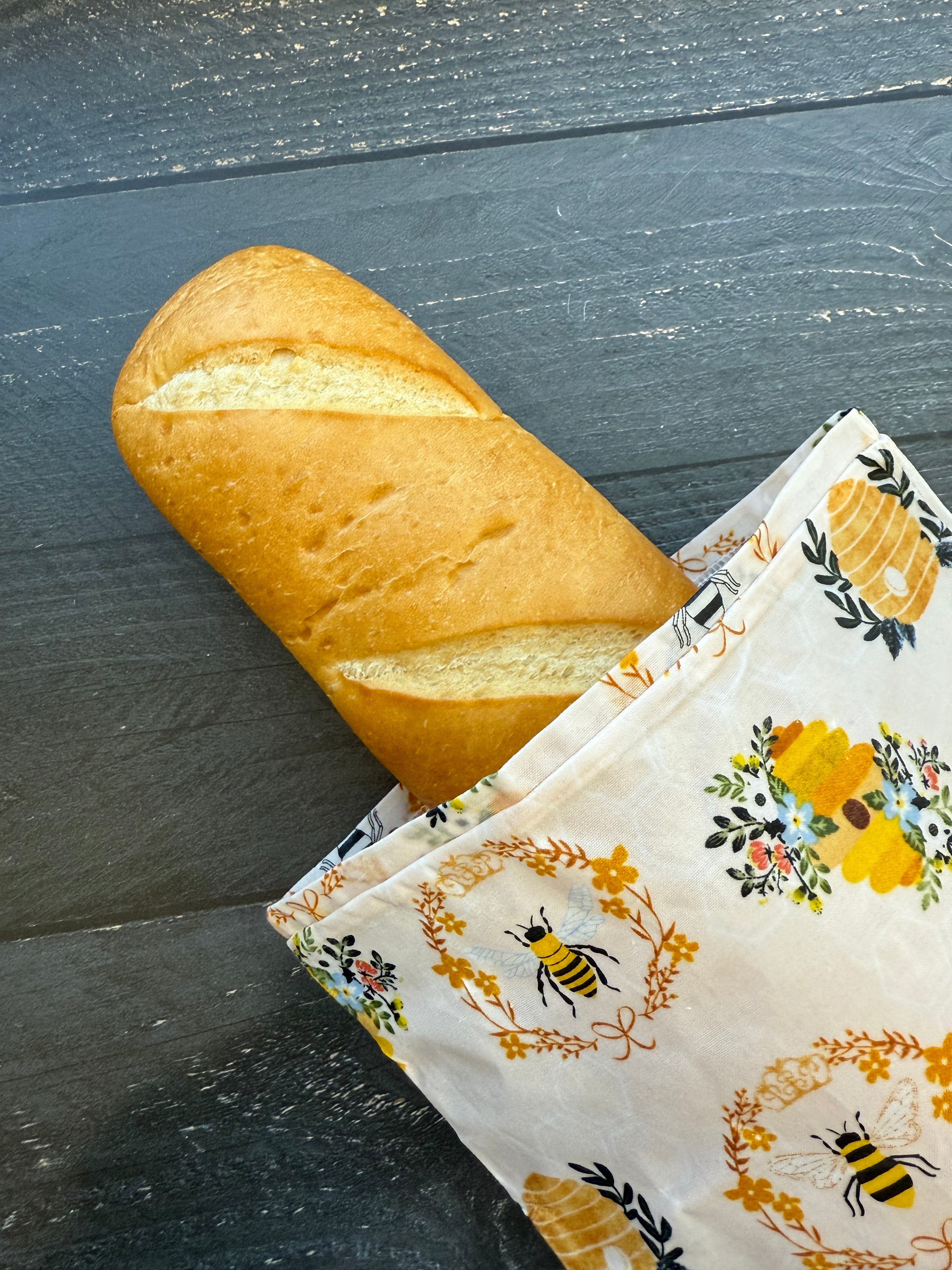Beeswax baguette bag holding a long loaf of French bread