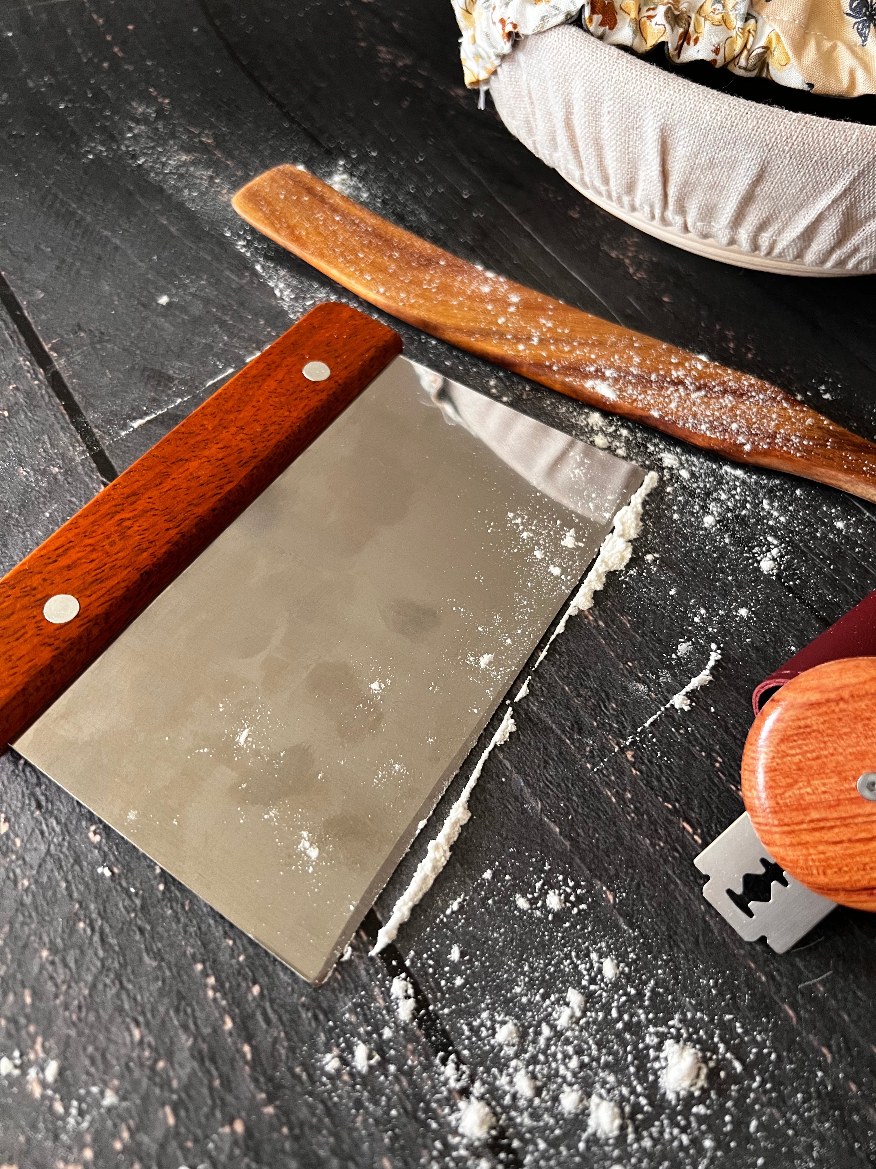 Wooden bench scraper clearing flour from the counter — Five Oaks Farm