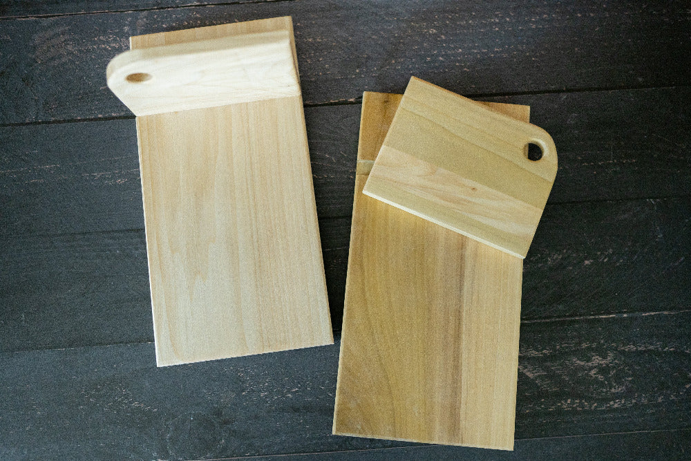 Vertical cutting board bracing a loaf of bread for slicing — Five Oaks Farm