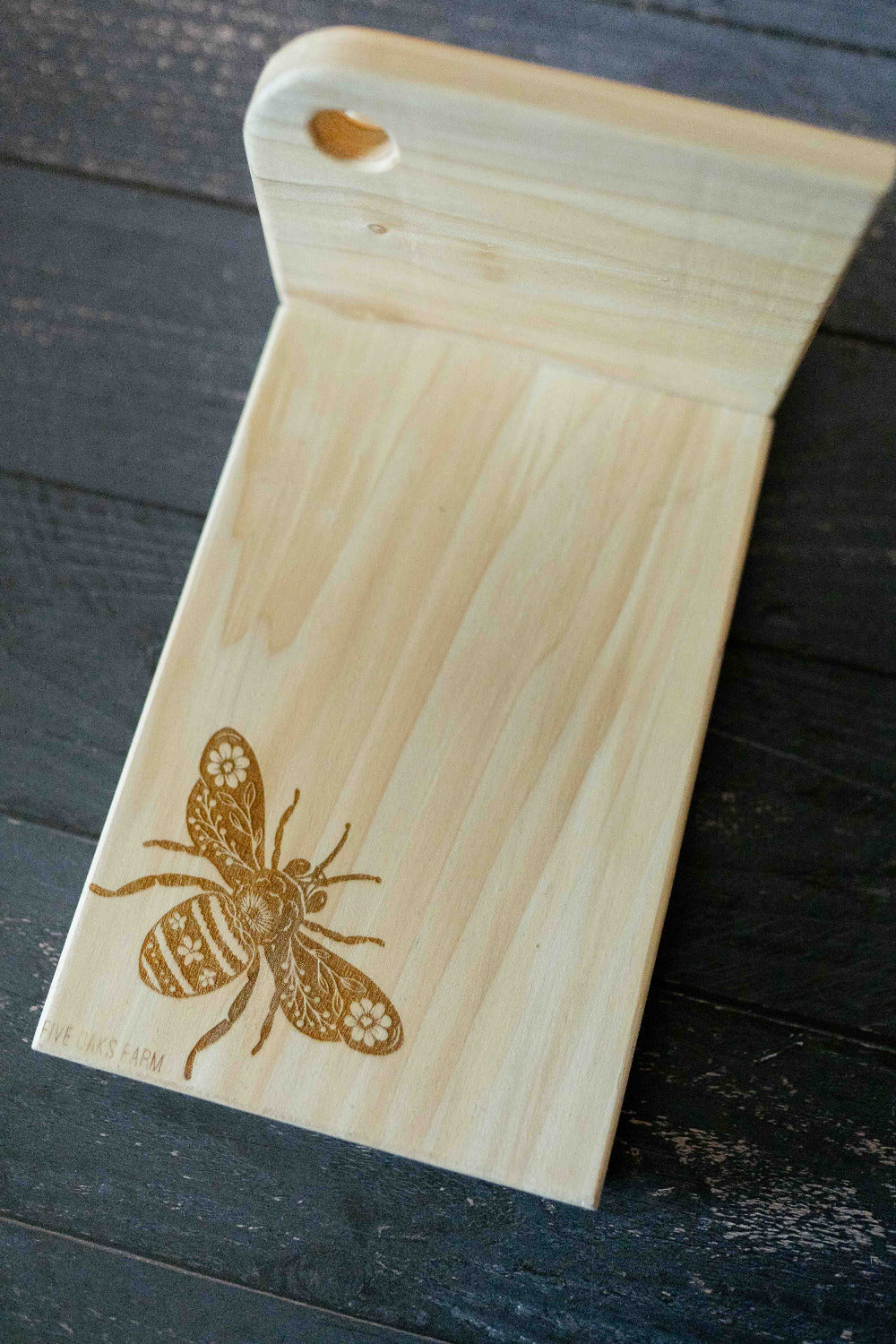 Vertical cutting board bracing a loaf of bread for slicing — Five Oaks Farm