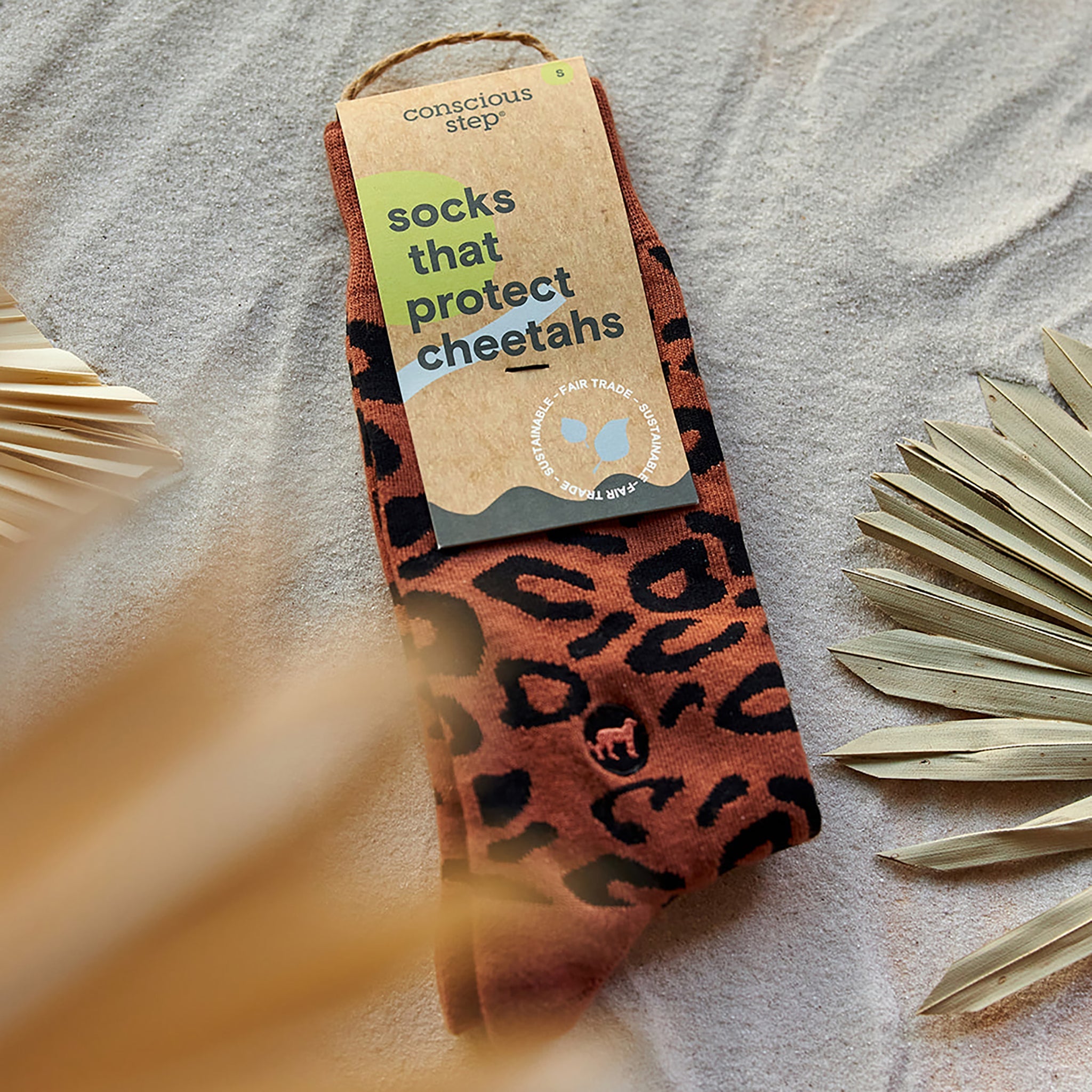 Close-up of rust leopard sock pattern — Conscious Step
